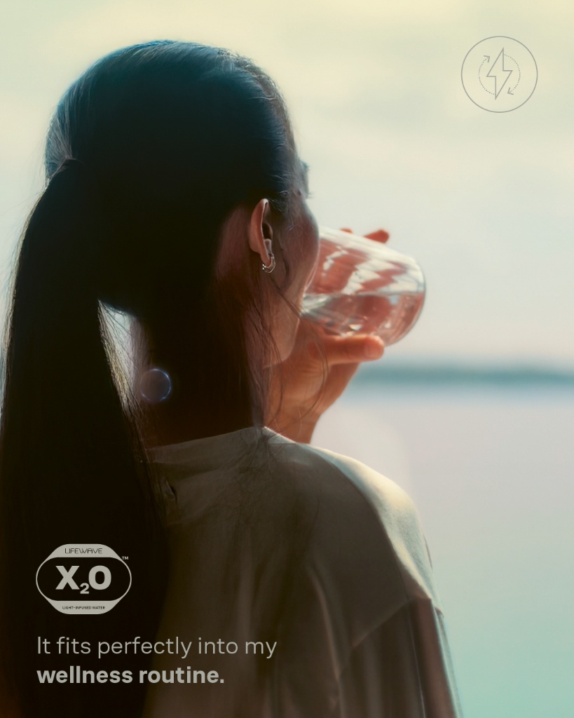 Woman drinking water as part of a daily wellness routine